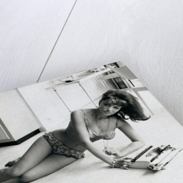 Jackie Collins, author and actress, and sister to Joan Collins, pictured in her Hampstead, London, flat on 6th August 1964 by Daily Mirror