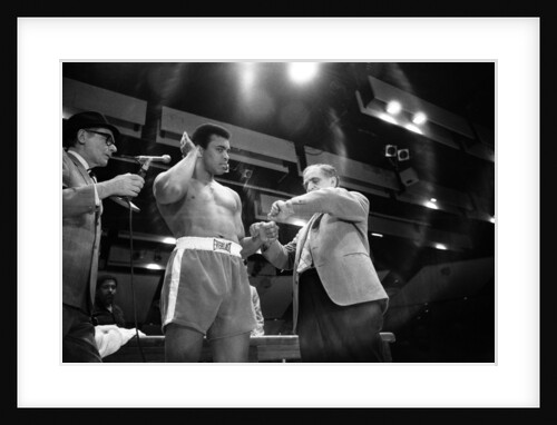 Muhammad Ali clowning around patting his hair. by Monte Fresco