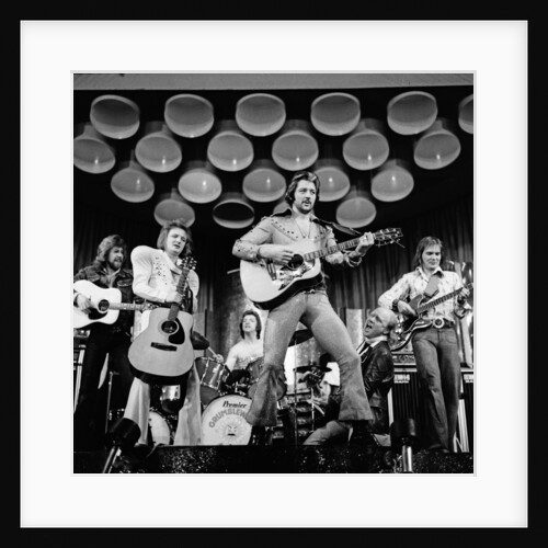 Frank worthington playing guitar 1975 by Dick Williams