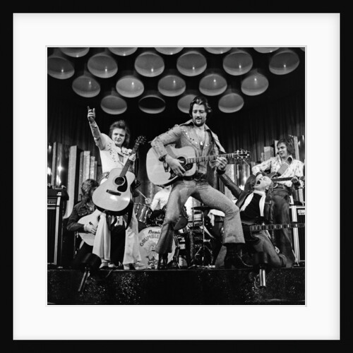 Frank worthington playing guitar 1975 by Dick Williams