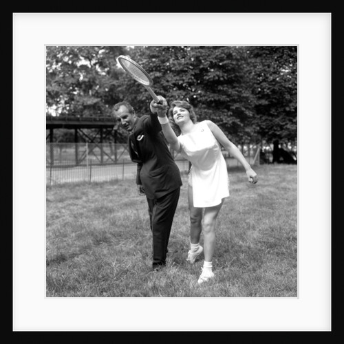 Fred Perry with actress Yvonne Buckingham, during a coaching session. by Staff