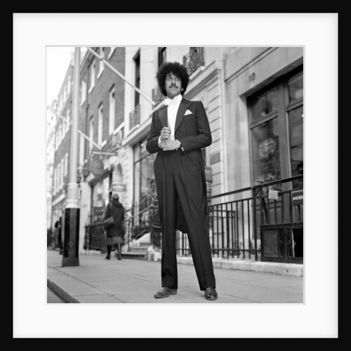 Phil Lynott in London, modelling clothes from Saville Row. 1983 by Mike Maloney