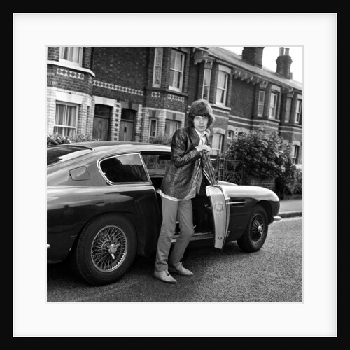 Mick Jagger with an Aston Martin by Unknown