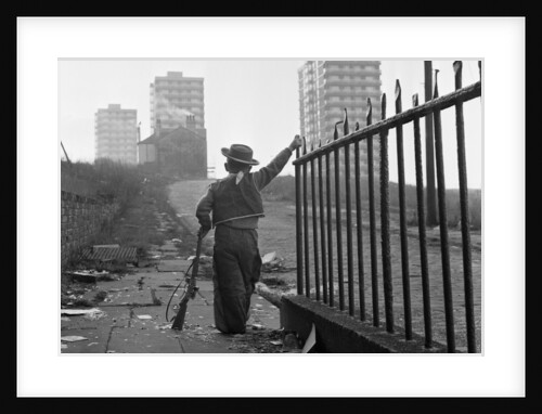 Young boy playing cowboys in Collyhurst by Dennis Hussey