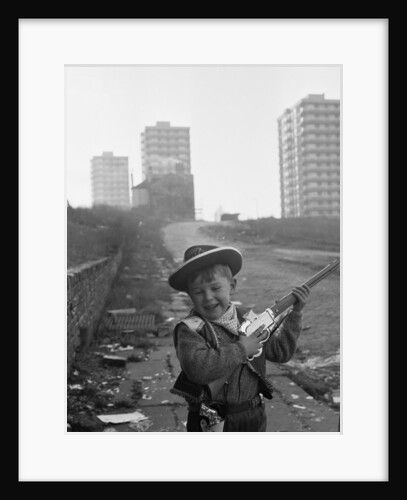 Young boy playing cowboys in Collyhurst by Dennis Hussey
