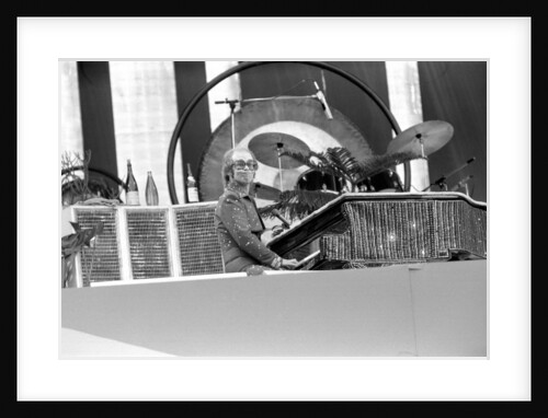 Elton John performing on stage at Wembley Stadium., London, England in June 1975 by Chris Barham