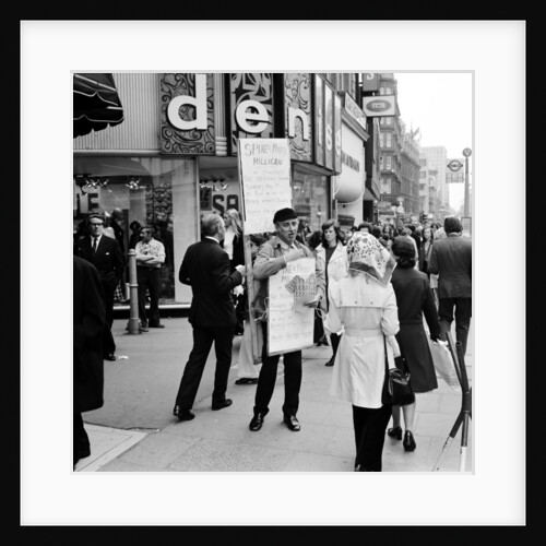 Spike Milligan & wife Paddy use a Sandwich board by Anonymous