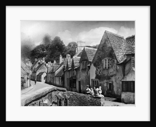 A family takes a rest on a stone wall in a Cotswold village in Gloucestershire by Anonymous