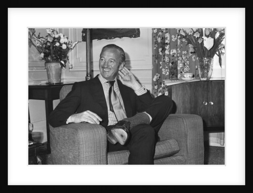 David Niven relaxes in his hotel suite in London by Anonymous