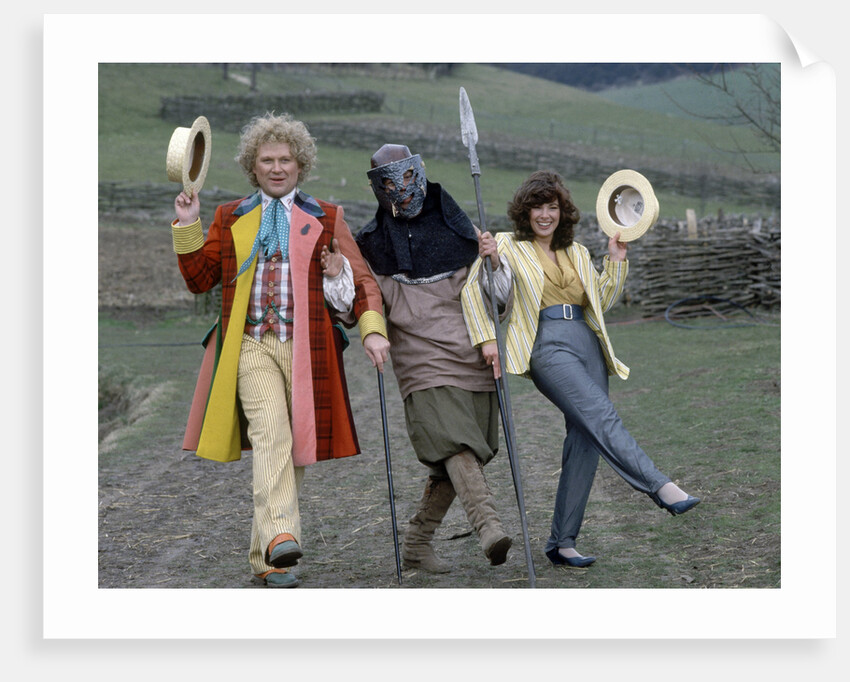 Colin Baker with Nicola Bryant who plays Perpugilliam "Peri" Brown during filming at Butser Ancient Farm Project, Butser Hill, Hampshire for the story The Mysterious Planet, part of the larger Trial of A Time Lord narrative. 10th April 1986. by Anonymous