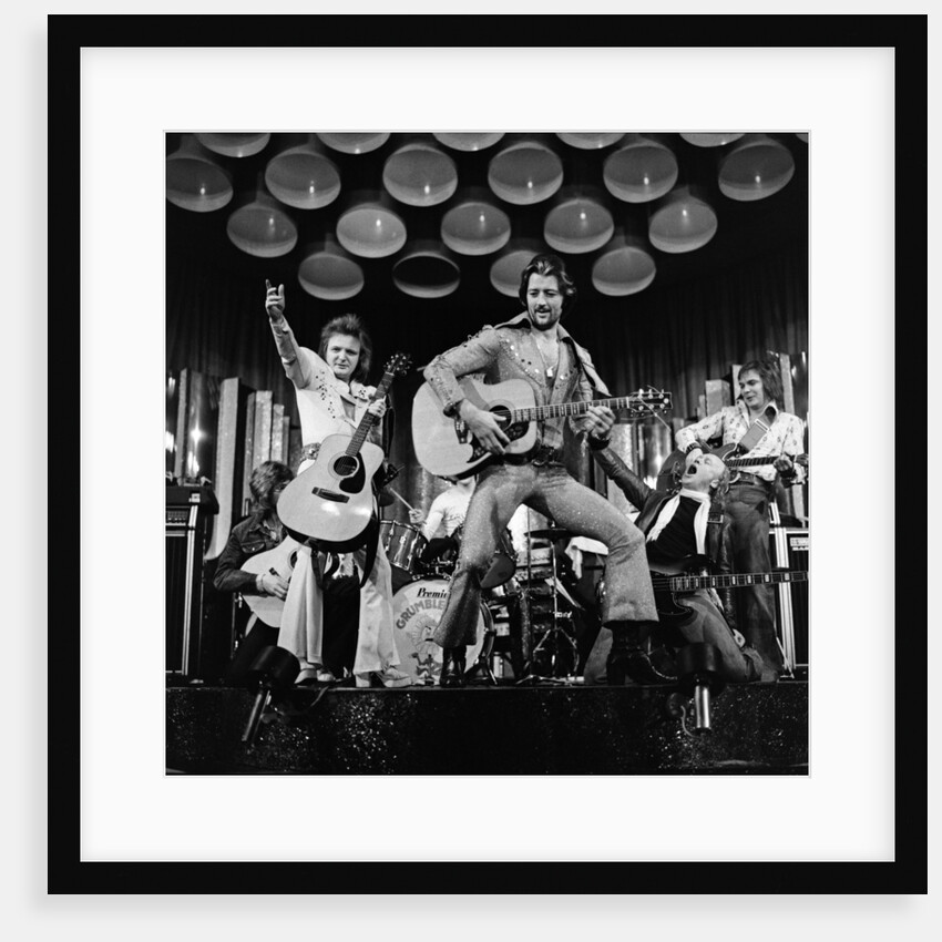 Frank worthington playing guitar 1975 by Dick Williams