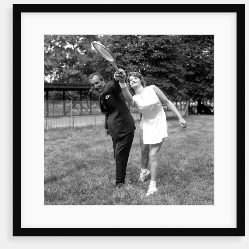 Fred Perry with actress Yvonne Buckingham, during a coaching session. by Staff