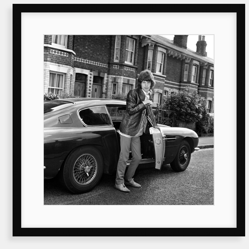 Mick Jagger with an Aston Martin by Unknown