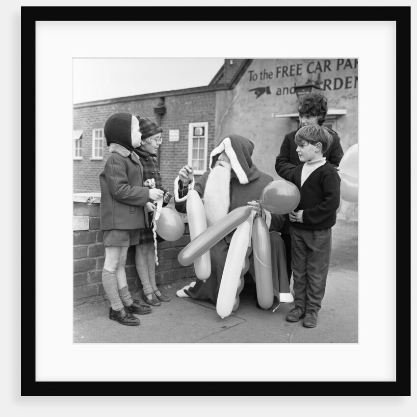 Father Christmas seen here handing out balloons in Tilhurst by Staff