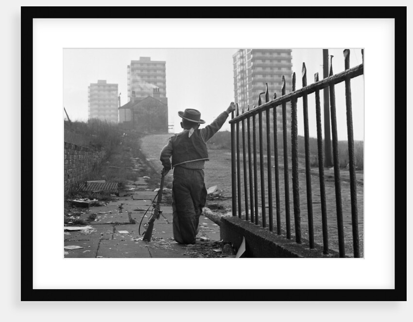 Young boy playing cowboys in Collyhurst by Dennis Hussey