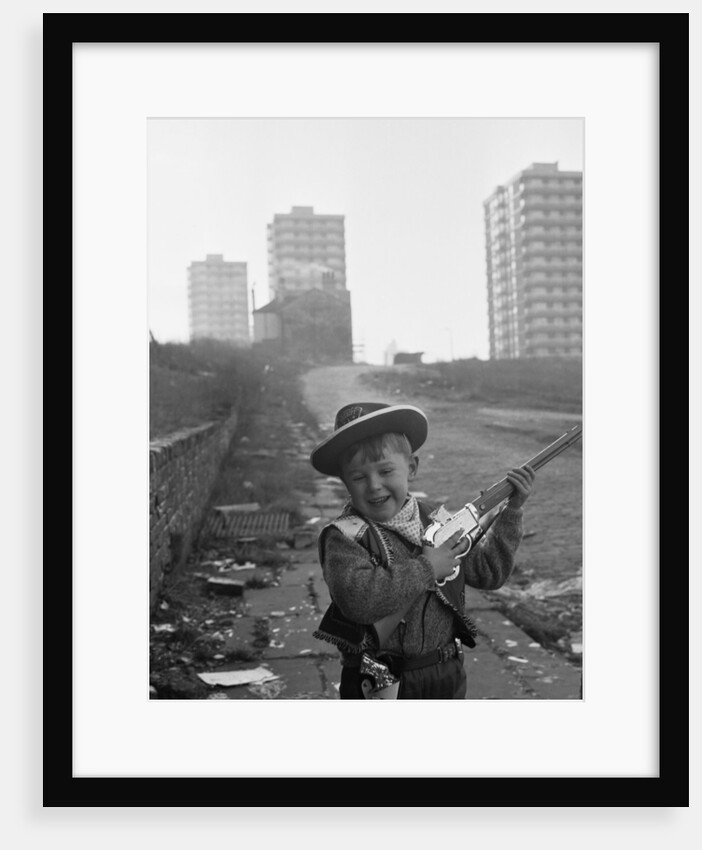 Young boy playing cowboys in Collyhurst by Dennis Hussey