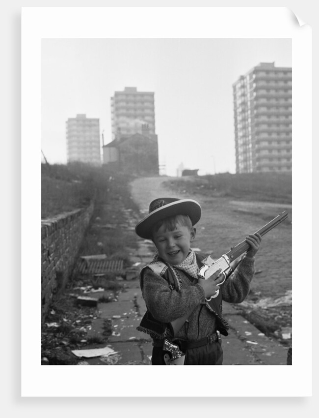 Young boy playing cowboys in Collyhurst by Dennis Hussey