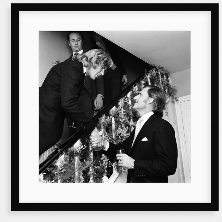 Motor racing driver & groom James Hunt shakes hands with Graham Hill on his wedding day by Anonymous