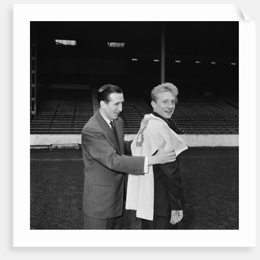 Manchester City new signing Denis Law with Ken Barnes trying his new shirt for size by Thomas