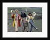 Colin Baker with Nicola Bryant who plays Perpugilliam "Peri" Brown during filming at Butser Ancient Farm Project, Butser Hill, Hampshire for the story The Mysterious Planet, part of the larger Trial of A Time Lord narrative. 10th April 1986. by Anonymous