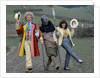 Colin Baker with Nicola Bryant who plays Perpugilliam "Peri" Brown during filming at Butser Ancient Farm Project, Butser Hill, Hampshire for the story The Mysterious Planet, part of the larger Trial of A Time Lord narrative. 10th April 1986. by Anonymous