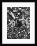 Young girl surrounded by hungry pigeons by Anonymous