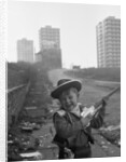 Young boy playing cowboys in Collyhurst by Dennis Hussey