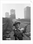 Young boy playing cowboys in Collyhurst by Dennis Hussey