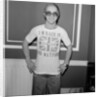 Elton John returns from America to announce that he is back in Britain for good. by Carl Bruin