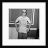 Elton John returns from America to announce that he is back in Britain for good. by Carl Bruin