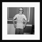 Elton John returns from America to announce that he is back in Britain for good. by Carl Bruin