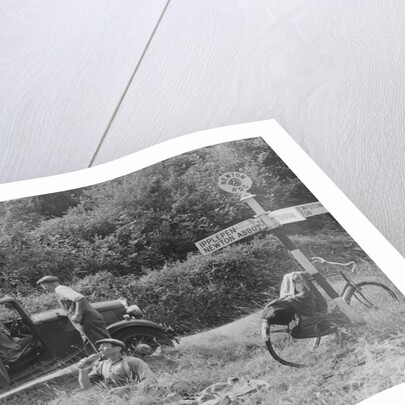 People relaxing by a signpost with a 1935 Standard 10 hp car, Devon, (c1935?) by Unknown