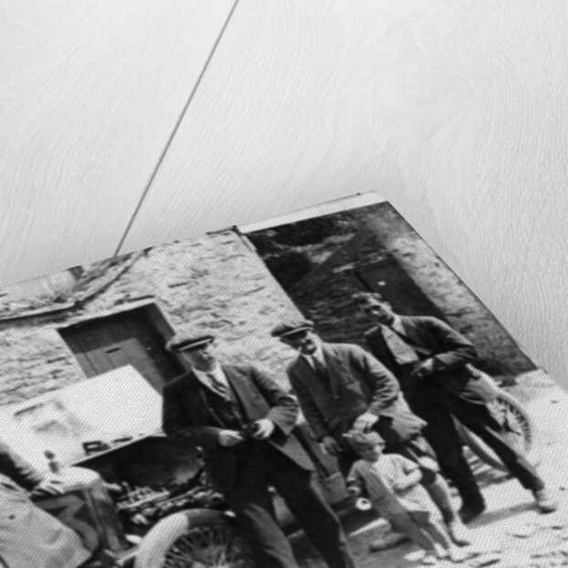 Bedford standing at the front of a car, with onlookers by Unknown