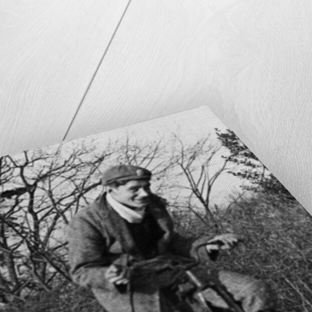 A young Lord Nuffield riding a bicycle down a country lane by Unknown