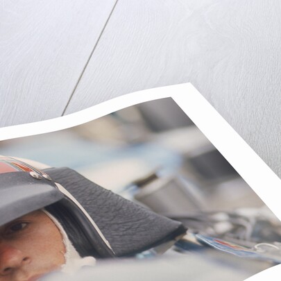 Jackie Stewart at the wheel of a racing car by Unknown