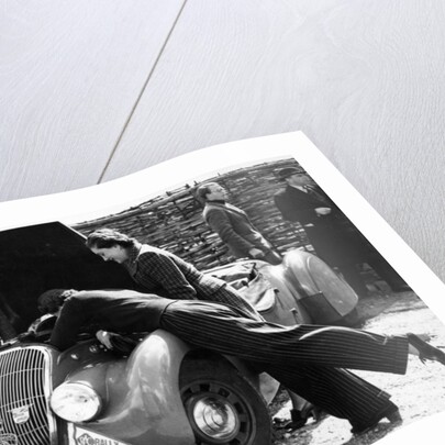 Miss MD Patten looking at the engine of a 1938 Peugeot 402 Special Sport, RAC Rally, 1939 by Unknown