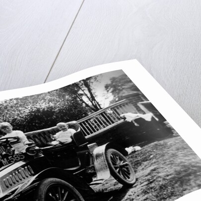 A child at the wheel of a De Dion Bouton car by Anonymous