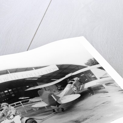 A Honda all terrain cycle pulling a vintage biplane by Anonymous