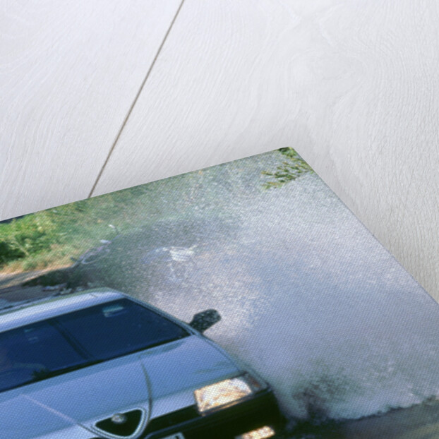 1989 Alfa Romeo 164 driving through a ford by Unknown