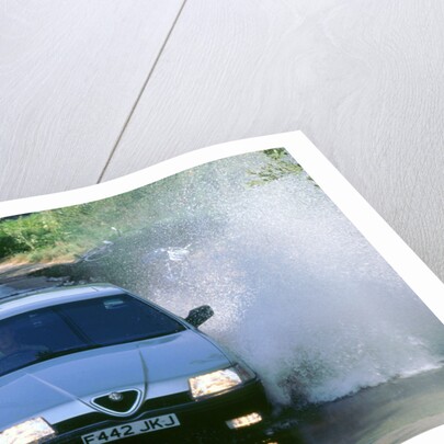 1989 Alfa Romeo 164 driving through a ford by Unknown