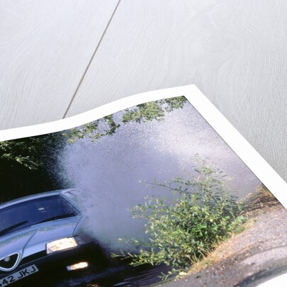 1989 Alfa Romeo 164 driving through a ford by Unknown