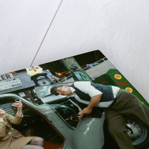 Mechanic with lady driver doing her make up, 1930's Hillman Minx by Unknown