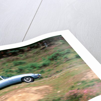 1965 Jaguar E type with smiling driver by Unknown