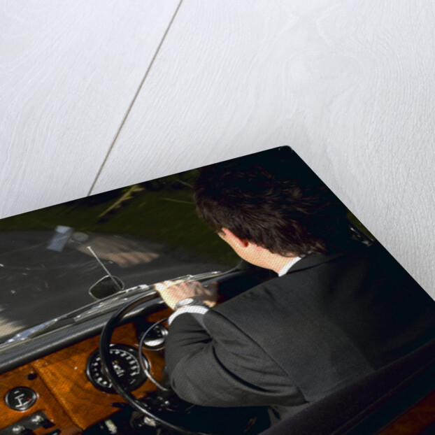 Chauffeur driving 1970 Daimler vanden plas DS 420 limousine by Unknown