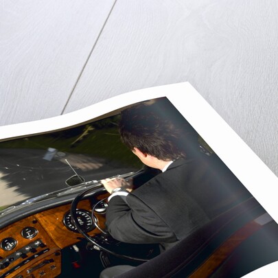 Chauffeur driving 1970 Daimler vanden plas DS 420 limousine by Unknown