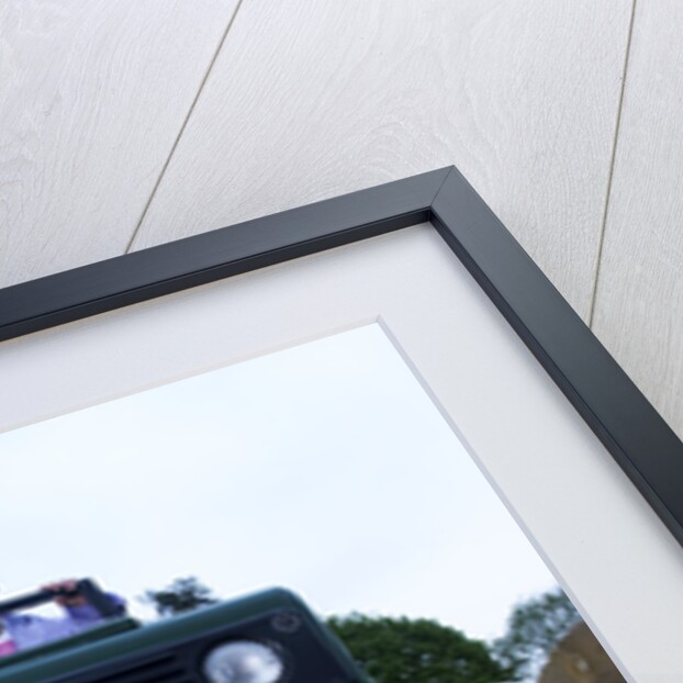 Child driving a toy Land Rover by Unknown
