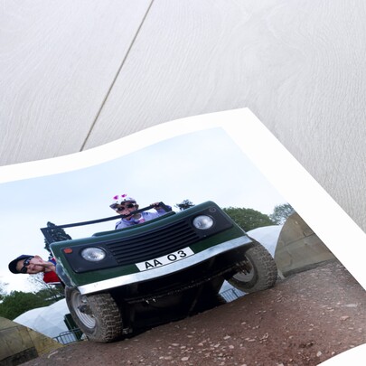 Child driving a toy Land Rover by Unknown