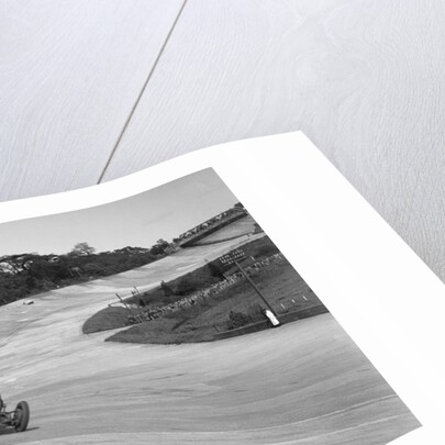 Eddie Hall's Bentley leading a Bugatti on the banking at Brooklands. by Bill Brunell