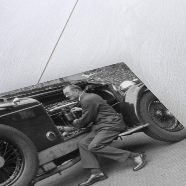 Geoffrey Baker inspecting the engine of a Minerva car by Bill Brunell