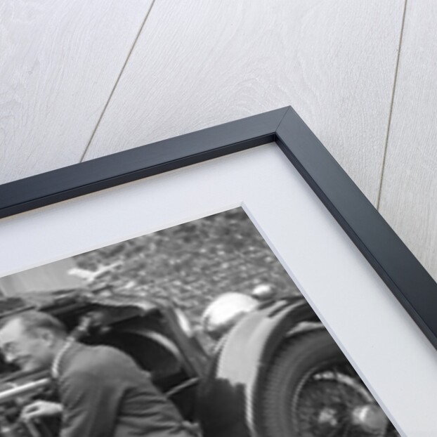 Geoffrey Baker inspecting the engine of a Minerva car by Bill Brunell